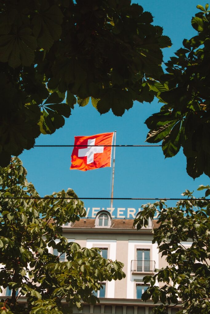 a flag flying in front of a tall building